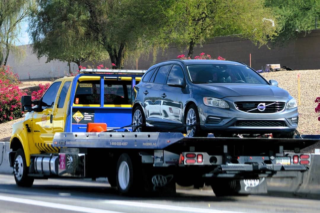 A roadside assistance truck picks up a car to service.